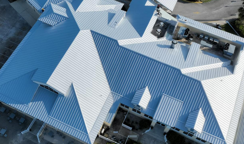 Luxury Home with Multi-Tiered Bright Grey Metal Roofing Panels.